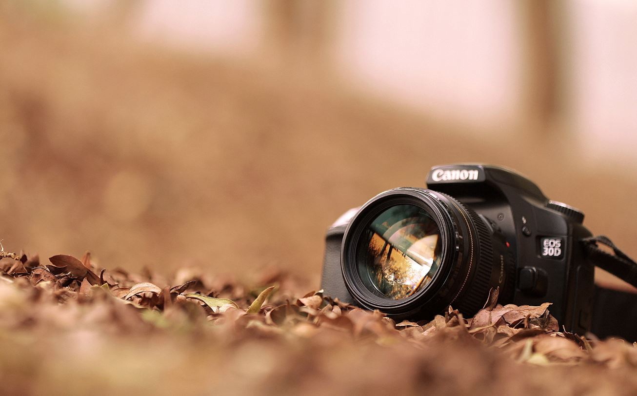 Camera lens reflecting soft mint light in studio setting